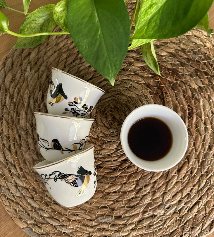 Kashida's Freedom Arabic coffee cups embody the tale of a bird in flight sharing her story of freedom with another bird. Rotate the cup to view Arabic letters disintegrate from the wings of the creature, signifying the spreading of her message to the world. The design is dynamic, featuring high contrasting colors which truly captivate the eye.