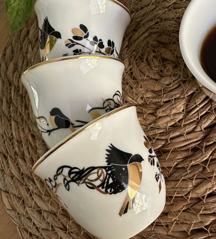 Kashida's Freedom Arabic coffee cups embody the tale of a bird in flight sharing her story of freedom with another bird. Rotate the cup to view Arabic letters disintegrate from the wings of the creature, signifying the spreading of her message to the world. The design is dynamic, featuring high contrasting colors which truly captivate the eye.