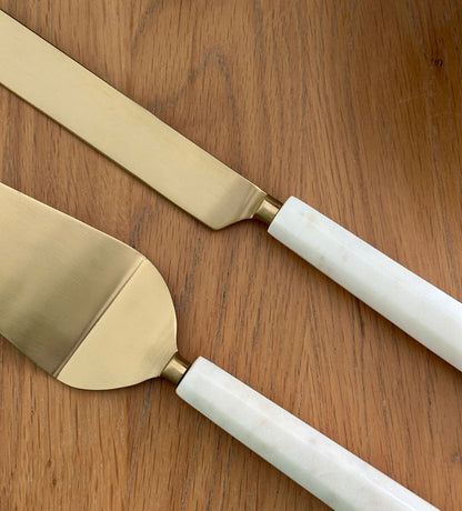 Elegant cake knife and servers made with marble and brass featuring Arabic calligraphy designs.