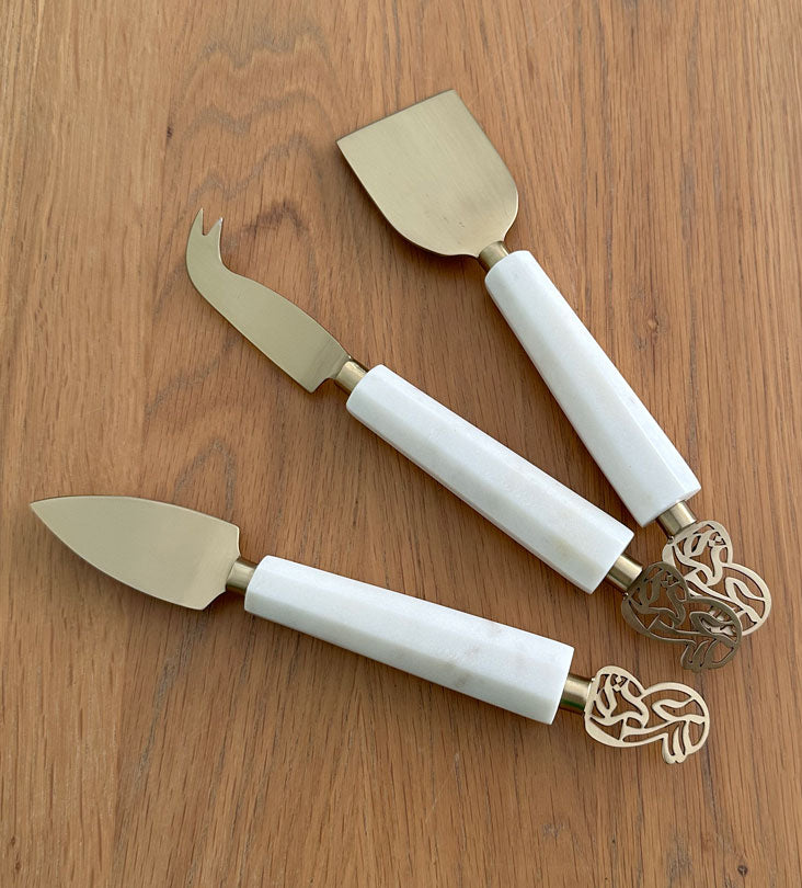 Elegant cheese knives set made with marble and brass featuring Arabic calligraphy designs.