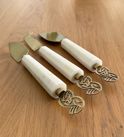 Elegant cheese knives set made with marble and brass featuring Arabic calligraphy designs.