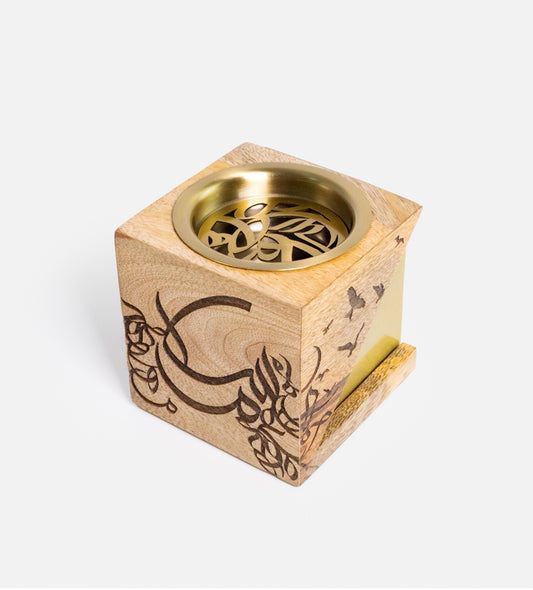 Cube-shaped incense burner made with wood and brass featuring Arabic calligraphy etchings, designed by Kashida.