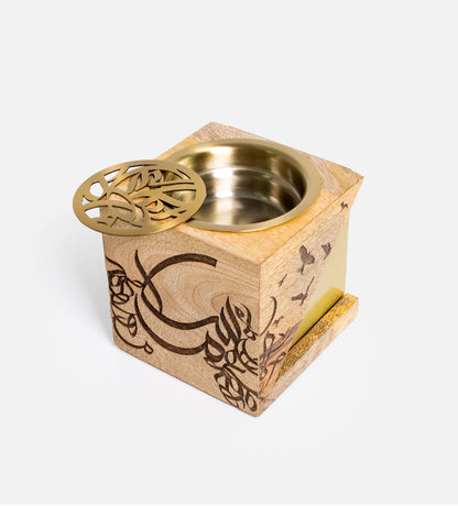 Cube-shaped incense burner made with wood and brass featuring Arabic calligraphy etchings, designed by Kashida.