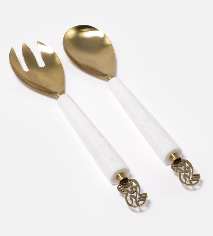 Elegant salad servers made with marble and brass featuring Arabic calligraphy designs.