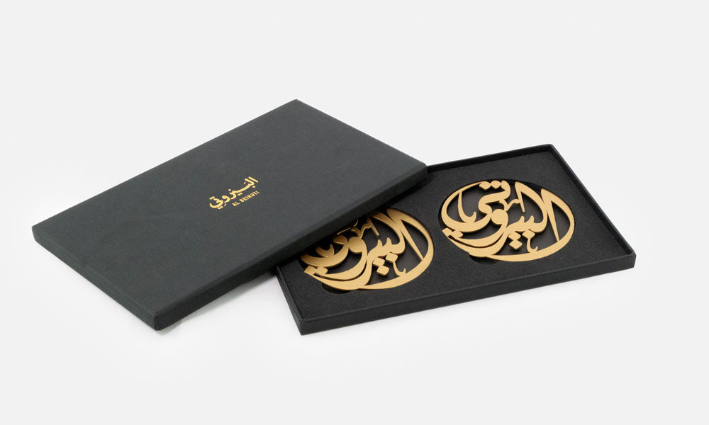 Gift set of beautiful steel cut coasters with Arabic calligraphy designed for Al Beiruti restaurant in Dubai by Kashida design