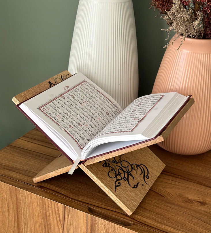 Handmade wooden quran holder featuring artwork of birds merged with Arabic calligraphy made with brass inlay