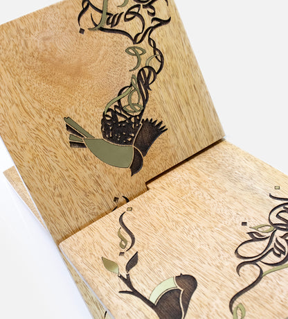 Handmade wooden quran holder featuring artwork of birds merged with Arabic calligraphy made with brass inlay