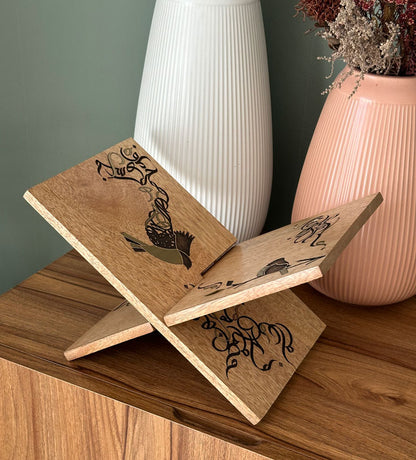 Handmade wooden quran holder featuring artwork of birds merged with Arabic calligraphy made with brass inlay