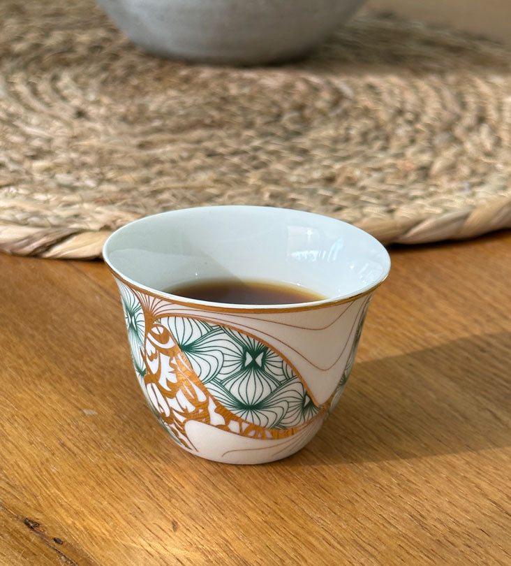 Porcelain Arabic coffee cup by Kashida in emerald green and gold hues