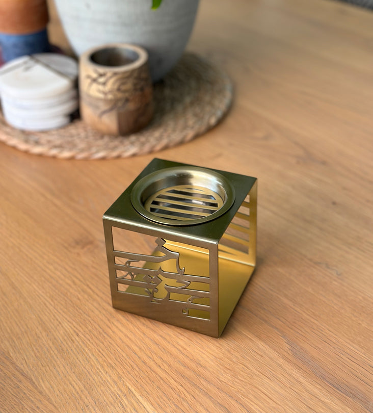 Cuboid metal incense burner made with brass sheet and Arabic calligraphy words cut through, designed by Kashida.