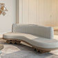 Modern fluid sofa with organic shape and simple neutral tone upholstery from Kashida's Nuqat collection.
