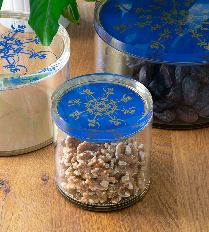 Small Acrylic cylinder container in royal blue and gold with Arabic calligraphy pattern for storing sweets