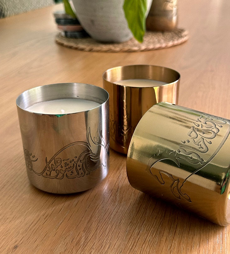 Hand-poured scented candles with fragrances that relate to the UAE in three beautiful metal canisters with Arabic calligraphy etchings featuring a poem by Sheikh Mohamad Bin Rashed Al Maktoum.