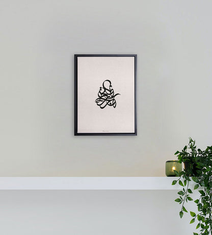 Modern simple Arabic calligraphy wall print sitting amidst a white canvas frame 