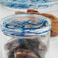 Contemporary transparent acrylic storage cylinders with Arabic calligraphy fluid art