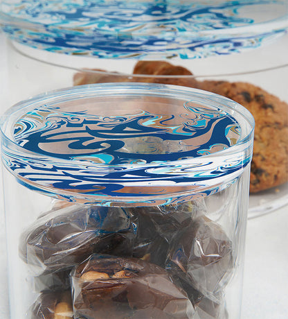 Contemporary transparent acrylic storage cylinders with Arabic calligraphy fluid art