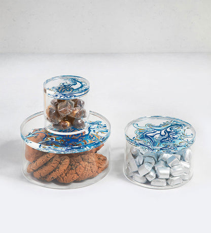 Contemporary transparent acrylic storage cylinders with Arabic calligraphy fluid art