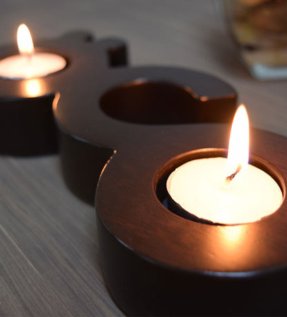 Flat wooden candleholder for tea light candles featuring the word candle in Arabic calligraphy