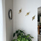 Beautiful brass plated decorative wall hangers shaped like origami birds with modern Arabic calligraphy designed by Kashida