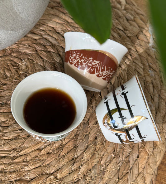 Modern Arabic coffee cup in Arabic calligraphy featuring a famous saying by Sheikh Zayed, founder of the UAE.