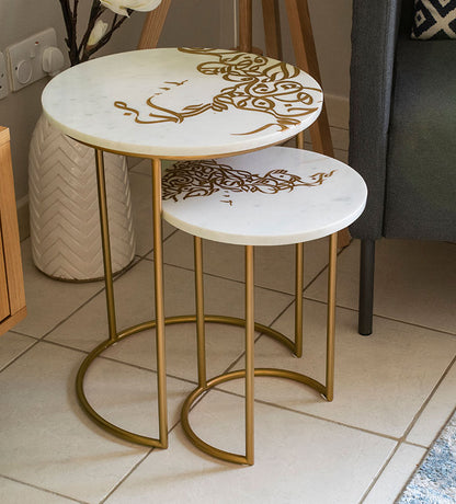 A set of two white marble side tables with contemporary Arabic graffiti etchings and a gold steel base