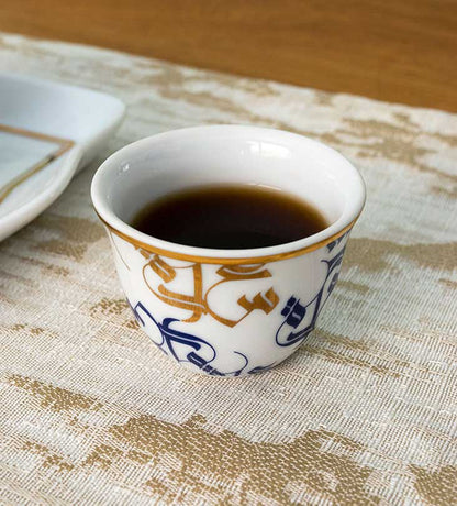 Traditional Arabic coffee cup finjal in royal blue and gold Arabic calligraphy pattern