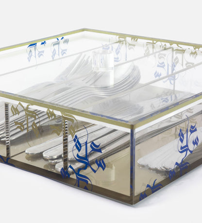 Transparent acrylic cutlery holder with four compartments featuring modern Arabic calligraphy by Kashida