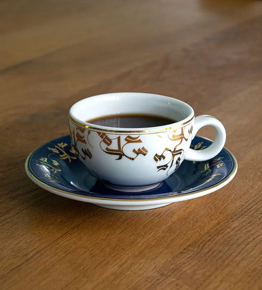 Elegant royal blue and gold tea cup and saucer with Arabic calligraphy pattern print on porcelain