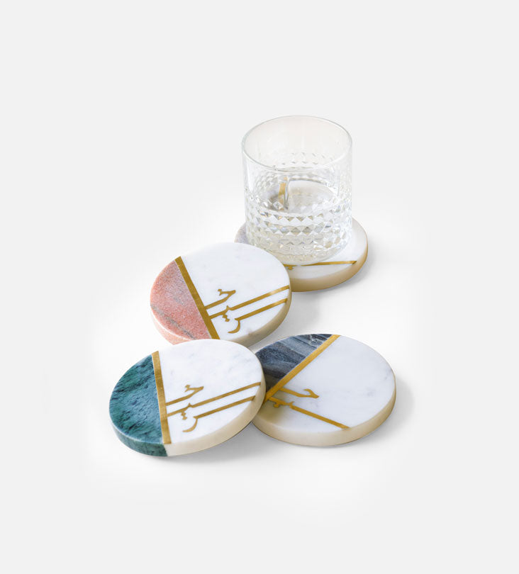 Beautiful pastel colored marble coasters with brass detail in Arabic calligraphy by Kashida